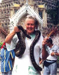 Bette Stanton in Thailand with a python snake